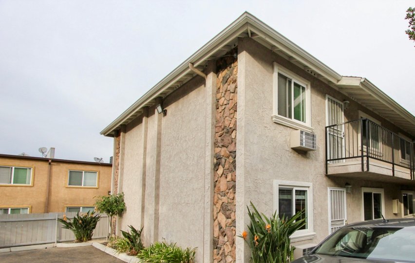 A side view of a property in Buena Vista Condominiums with a car