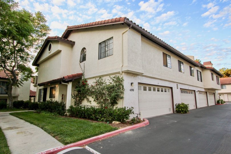 Two-story house with multiple parking garages and sidewalk, located in Las Palmas, University City, California.